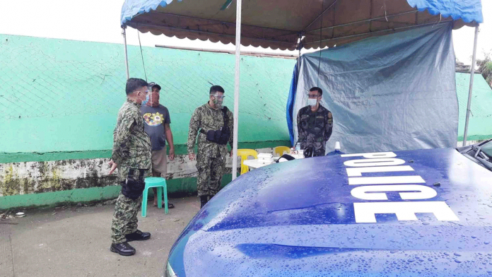 region-kalibo-lock Policemen set up this makeshift tent at the entrance of a purok in Kalibo, Aklan that is under a surgical lockdown due to a surge in cases of coronavirus disease. PHOTO BY KALIBO PNP
