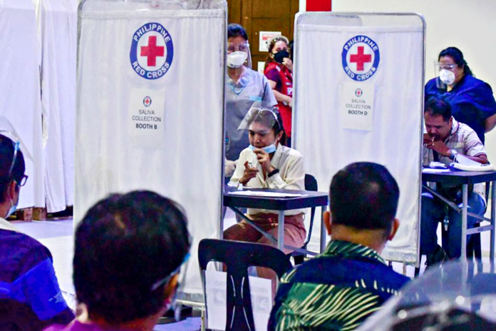 saliva-test The saliva reverse transcription polymerase chain reaction test pilot at the Philippine Red Cross headquarters in Mandaluyong City on Jan. 12 gets approval from the Department of Health as a new alternative testing method. MARK DEMAYO, ABS-CBN NEWS
