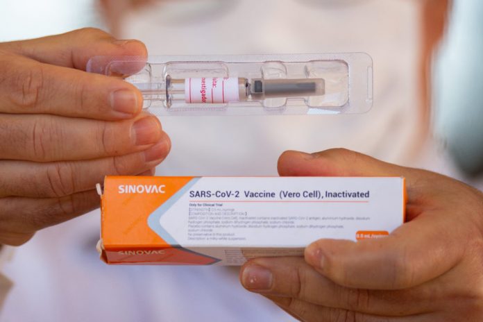 A professor at the University of Brasilia shows the vaccine to journalists amidst the coronavirus pandemic on Aug. 5, 2020 in Brazil. ANDRESSA ANHOLETE/GETTY IMAGES A professor at the University of Brasilia shows the vaccine to journalists amidst the coronavirus pandemic on Aug. 5, 2020 in Brazil. ANDRESSA ANHOLETE/GETTY IMAGES