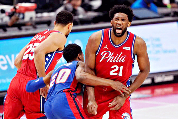 Philadelphia 76ers center Joel Embiid grimaces after Detroit Pistons guard Josh Jackson ran into him while chasing guard Ben Simmons during the first half of an NBA basketball game on Jan. 23, 2021. CARLOS OSORIO/AP Philadelphia 76ers center Joel Embiid grimaces after Detroit Pistons guard Josh Jackson ran into him while chasing guard Ben Simmons during the first half of an NBA basketball game on Jan. 23, 2021. CARLOS OSORIO/AP