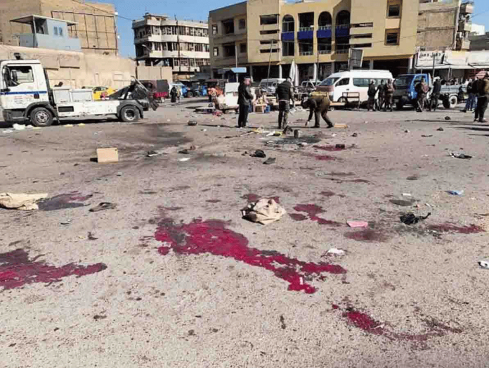 world-bombing Security forces work at the site of a deadly bomb attack in a market selling used clothes, Iraq on Jan. 21, 2021. AP PHOTO