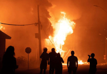 Protests erupt in Chilean resort Protesters set a public building on fire after a police officer shot and killed a street performer in Panguipulli on Feb. 5. ANDRES QUEZADA/REUTERS