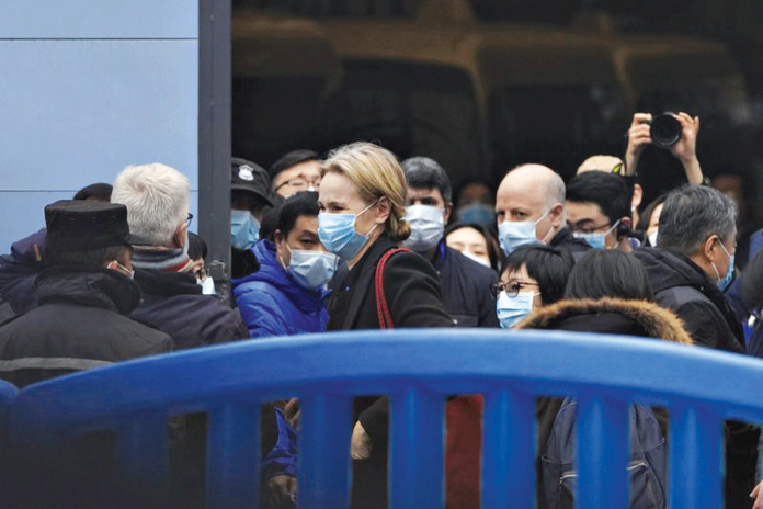 China-fires-back The World Health Organization team is briefed outside the Huanan seafood market on the third day of their field visit in Wuhan, China. The market was initially suspected as the place where people first became infected with coronavirus disease 2019. AP PHOTO/NG HAN GUAN