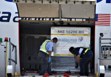 Malaysia to start COVID-19 vaccination drive early Containers carrying the first batch of Pfizer-BioNTech coronavirus disease 2019 vaccines are unloaded from a plane at the MASkargo Complex in Sepang, Malaysia on Feb. 21, 2021. MALAYSIA INFORMATION DEPARTMENT/FANDY AZLAN/HANDOUT VIA REUTERS