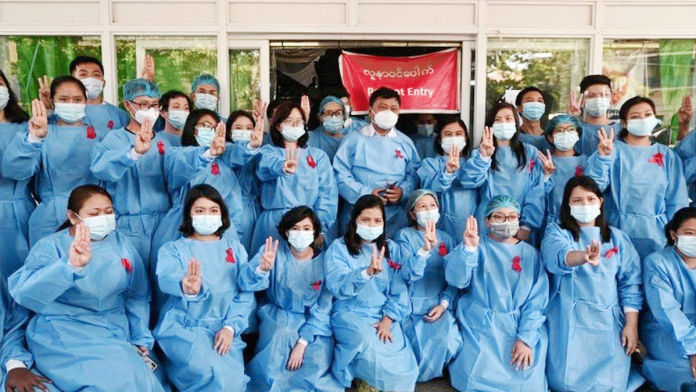 Myanmar Medics in Yangon General Hospital wear red ribbons as a sign of protest. REUTERS
