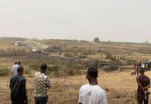 Nigerian air force passenger plane crash kills seven people People watch as rescuers inspect the debris from a Nigerian air force plane which crashed while approaching the Abuja airport runway on Feb. 21, 2021. REUTERS/ABRAHAM ACHIRGA
