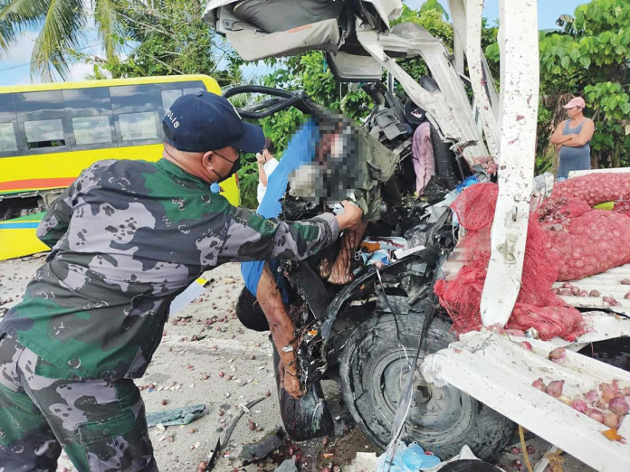 accident FREAK ACCIDENT. This policeman checks the body of Johnny Delariarte pinned by the wreckage of his truck that crashed against a Ceres bus in Barangay Cabilauan, Barotac Nuevo, Iloilo yesterday. BAROTAC NUEVO POLICE STATION