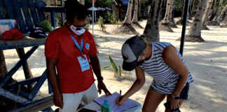 A tourist registers at the lifeguard station before swimming in the waters of Boracay Island. PNA/ YES THE BEST BORACAY