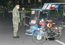 Policemen investigate a shooting incident that left 29-year-old Medelyn Benignos dead in Barangay 8, Bacolod City on Feb. 20. POLICE STATION 2/BCPO