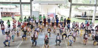After many years of waiting, agrarian reform beneficiaries in Barangay San Nicolas, Buenavista, Guimaras are finally holding the titles to their lands issued by the Department of Agrarian Reform. They are shown here observing physical distancing during the land title distribution at the covered gym of Barangay San Nicolas.