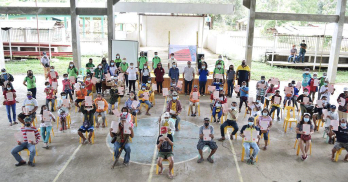 region-ime-ARB-pic After many years of waiting, agrarian reform beneficiaries in Barangay San Nicolas, Buenavista, Guimaras are finally holding the titles to their lands issued by the Department of Agrarian Reform. They are shown here observing physical distancing during the land title distribution at the covered gym of Barangay San Nicolas.