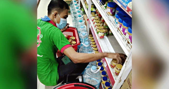 retailers A store personnel pulls out items with pork ingredients in San Jose, Antique following an appeal for such from the Antique African swine fever task force. PROVET PHOTO