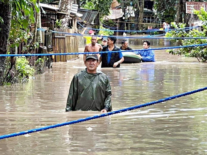 talisay-flood-pic Residents of a flood-hit village in Talisay City, Negros Occidental evacuate on Feb. 22. The Office of Civil Defense Region 6 reported no casualties due to tropical depression “Auring.” PHOTO BY CDRRMO TALISAY CITY