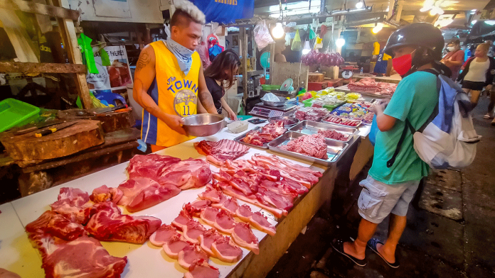 ASF A vendor tends his meat stall in one of the public markets in Iloilo City. The African swine fever outbreak is blamed for the spike in retail prices of pork in the country. PANAY NEWS PHOTO
