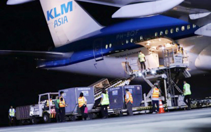 Boxes containing vials of AstraZeneca vaccines are offloaded from KLM Asia that flew in from Amsterdam on March 7, 2021. The 38,400 doses are part of 525,600 secured through the COVAX Facility. PNA/ROBERT ALFILER