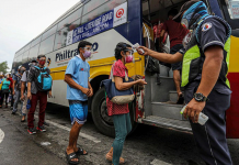 PH logs 8K more COVID-19 cases Commuters queue in a bus stop in Quezon City. Before entering the bus, they are required to undergo body temperature check. JIRE CARREON/ABS-CBN NEWS