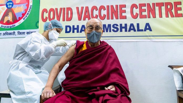 Dalai-Lama-gets-his A healthcare worker injects a coronavirus disease 2019 vaccine at Tibetan spiritual leader, the Dalai Lama. EPA