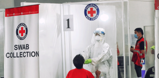 A staff from the Philippine Red Cross conducts swab test. The Philippine Health Insurance Corporation owes the Philippine Red Cross P822 million for coronavirus disease 2019 tests. IFRC