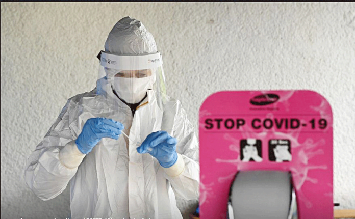 Slovakia A healthcare worker tests a sample at a coronavirus disease 2019 testing site during the nationwide testing in Trencin, Slovakia. REUTERS FILE PHOTO/RADOVAN STOKLASA