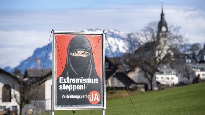 Posters promoted by the Swiss People's Party feature a woman in a black niqab and captions such as "Stop extremism!" and "Stop radical Islam!" EPA VIA BBC