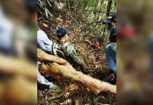Residents discover a cadaver at the foot of a cliff in Barangay Bunga, Don Salvador Benedicto, Negros Occidental on March 22. DON SALVADOR BENEDICTO PNP