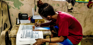 Jerry Calzado, 16, a student of Cayos National High School in Dumangas, Iloilo, answers his learning module. He prefers distance learning because while at home he could help his parents with the household chores. Panay News Photo