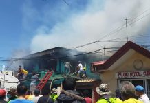Residents and firemen attempt to put out a fire that gutted two ancestral houses in Barangay Poblacion Ilaya, Passi City, Iloilo Monday afternoon./CIO LGU PASSI