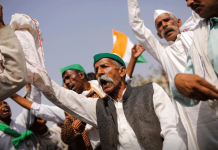 Indian farmers mark four months of protests Farmers dance as they sing a folk song during a 12-hour strike, as part of protests against farm laws, on a highway at the Delhi-Uttar Pradesh border in Ghaziabad, India. REUTERS/ADNAN ABIDI