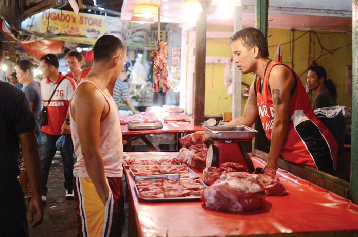 pork-vendor A meat vendor sells pork to a customer. In Negros Occidental, the Provincial Veterinary Office monitors a slight drop in the average price of pork from March 15 to 21. PN FILE PHOTO