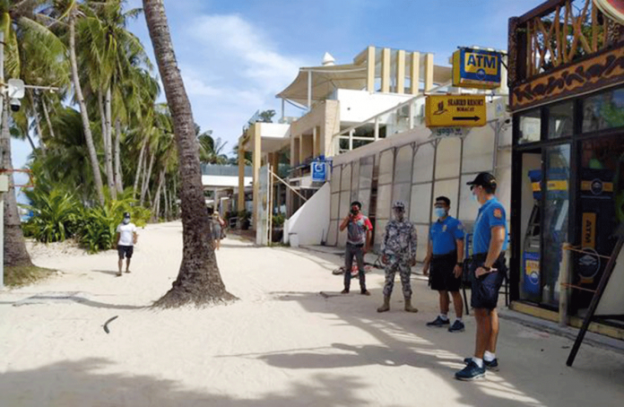region-boracay-purok Tourists are sparse, according to these policemen monitoring the situation of Boracay Island’s beachfront. PHOTO BY MALAY POLICE STATION
