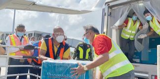 SINOVAC’S ARRIVAL. Cold chain and logistics personnel of the Western Visayas’ Vaccination Operations Center facilitate the offloading of Sinovac vaccines at the Iloilo International Airport in Cabatuan town. These vaccines are intended for four COVID-19 referral hospitals in Iloilo. PHOTO BY OCD-6