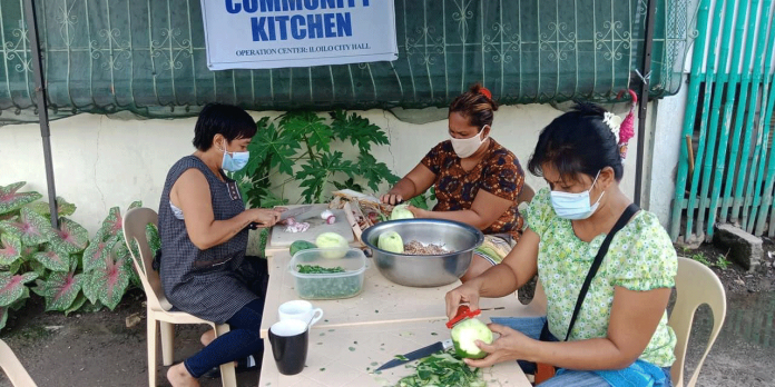 Nation1-banner These women prepare the ingredients of the food they will cook in one of the community kitchens in Iloilo City. During the onslaught of the coronavirus disease 2019, community kitchens were put up to feed the affected families in barangays under lockdown. JERRY TREÑAS/FACEBOOK