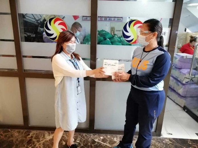 Ms. Louise Serojales handing one of 375 boxes of N-95 face masks to PLt.Col Regina N. Basco of the PNP-MRF. Ms. Louise Serojales handing one of 375 boxes of N-95 face masks to PLt.Col Regina N. Basco of the PNP-MRF.