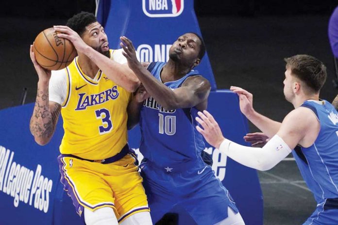 Sports-1-banner Los Angeles Lakers’ Anthony Davis (3) attempts to shoot the ball against Dallas Mavericks’ Dorian Finney-Smith (10) and Luka Doncic (right) during the first half of their basketball game in Dallas, Thursday. AP