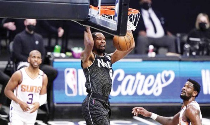Sports-1-banner Brooklyn Nets forward Kevin Durant (7) stuns Phoenix Suns with a dunk during the third quarter of their basketball game on Sunday, April 25, in New York. AP PHOTO/KATHY WILLENS