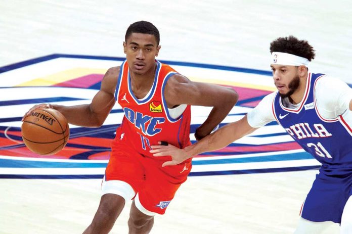 Oklahoma City Thunder’s Theo Maledon (11) dribbles past Philadelphia 76ers’ Seth Curry (31) during their game in the 2020-2021 NBA Season, Saturday, in Oklahoma City. AP/GARETT FISBECK Oklahoma City Thunder’s Theo Maledon (11) dribbles past Philadelphia 76ers’ Seth Curry (31) during their game in the 2020-2021 NBA Season, Saturday, in Oklahoma City. AP/GARETT FISBECK