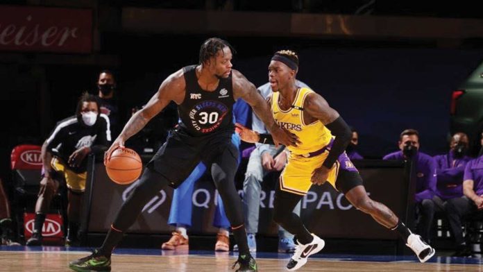 New York Knicks' Julius Randle (30) backs down the defense of Los Angeles Lakers' Dennis Schroder during their basketball match, Monday, at Madison Square Garden in New York. The Knicks seized the victory against Los Angeles Lakers, 111-96. NATHANIEL BUTLER/GETTY IMAGES