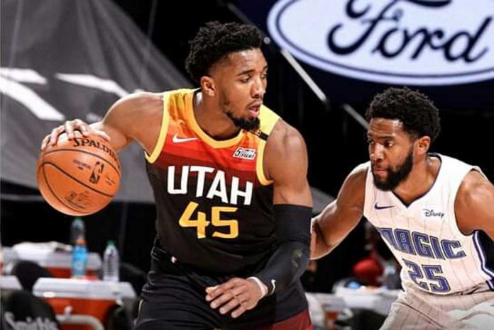 Utah Jazz's Donovan Mitchell (45) escapes the defense of Orlando Magic’s Chasson Randle (25) during the 2020-2021 NBA game on Saturday at Vivint Smart Home Arena in Salt Lake City, Utah. UNIVERSITY OF UTAH