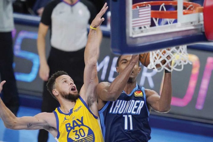 Golden State Warriors' Stephen Curry (left) attempts to block the shot of Oklahoma City Thunder's Theo Maledon (right) during their match in the 2020-2021 NBA game, Wednesday, in Oklahoma City. SUE OGROCKI/AP Golden State Warriors' Stephen Curry (left) attempts to block the shot of Oklahoma City Thunder's Theo Maledon (right) during their match in the 2020-2021 NBA game, Wednesday, in Oklahoma City. SUE OGROCKI/AP