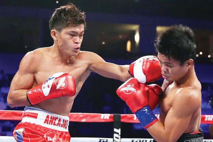 Sports-3 Jerwin Ancajas (left) lands a punch against fellow Filipino fighter Jonas Sultan (right) during their world title clash in 2018. This weekend, Ancajas will defend his IBF World super-flyweight title against Mexican Jonathan Rodriguez. TOP RANK PHOTO