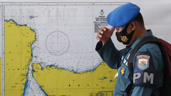 An officer stands in front of a map of the search area for the KRI Nanggala 402. EPA An officer stands in front of a map of the search area for the KRI Nanggala 402. EPA
