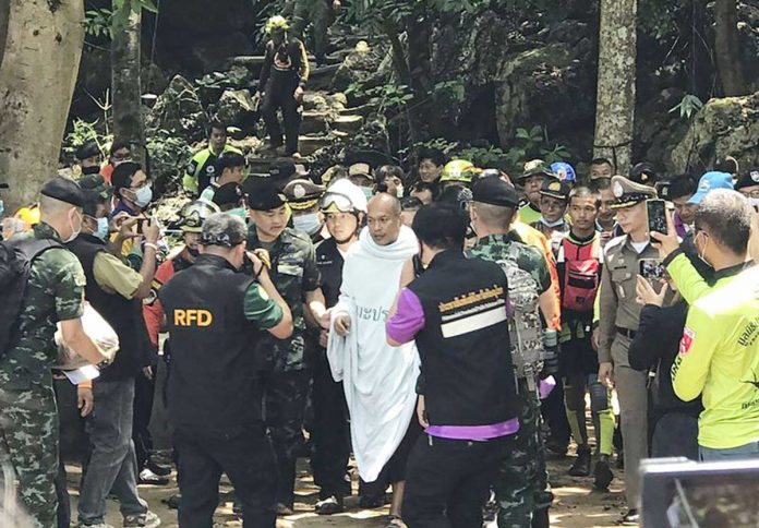 Rescuers help Phra Manas (center) walk out from Tham Phra Sai Ngam cave in Thailand on Wednesday. The 46-year-old monk was trapped inside a cave for four days. AP Rescuers help Phra Manas (center) walk out from Tham Phra Sai Ngam cave in Thailand on Wednesday. The 46-year-old monk was trapped inside a cave for four days. AP