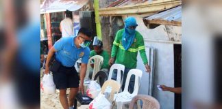 A policeman, assisted by volunteers, delivers food packs to locked down households in Boracay Island. The Municipal Inter-Agency Task Force of Malay, Aklan recommended an enhanced community quarantine in Barangay Balabag and surgical lockdown in Zone 1 and Zone 7 of Barangay Manocmanoc. PHOTO MALAY AKLAN PNP