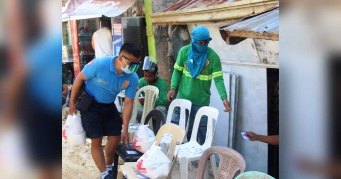 boracay A policeman, assisted by volunteers, delivers food packs to locked down households in Boracay Island. The Municipal Inter-Agency Task Force of Malay, Aklan recommended an enhanced community quarantine in Barangay Balabag and surgical lockdown in Zone 1 and Zone 7 of Barangay Manocmanoc. PHOTO MALAY AKLAN PNP
