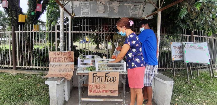 community-pantry A woman avails herself of vegetables displayed at a community pantry in New Lucena, Iloilo. This initiative has spread throughout the country, but some of its organizers were reportedly “red-tagged” by the police. On Tuesday, the Palace said “red-taggers” should not interfere with the works of the community pantries. PANAY NEWS PHOTO