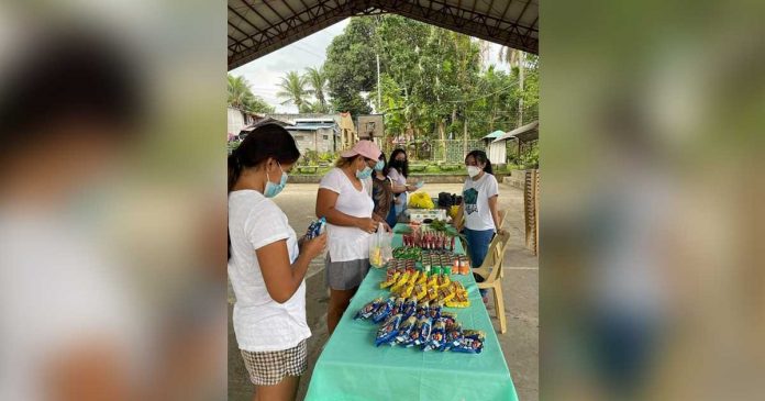 community-pantry This woman avails herself of noodles and canned goods displayed at a community pantry in Sta. Barbara, Iloilo. Organizers should follow health and safety protocols in the distribution of goods and other essentials because failure to do so will lead to closure of the pantry, the Department of Interior and Local Government warns. JAP FAJARDO/PN
