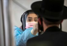 A healthcare worker takes a swab sample from an overseas returnee at Ben Gurion International Airport in Lod, Israel. The country has recorded eight cases of the virus’ Indian variant. REUTERS/RONEN ZVULUN/FILE PHOTO