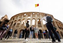 People wait outside the Colosseum on the day of its reopening, as much of the country becomes a 'yellow zone', easing coronavirus disease restrictions, in Rome, Italy, April 26. REUTERS/GUGLIELMO MANGIAPANE