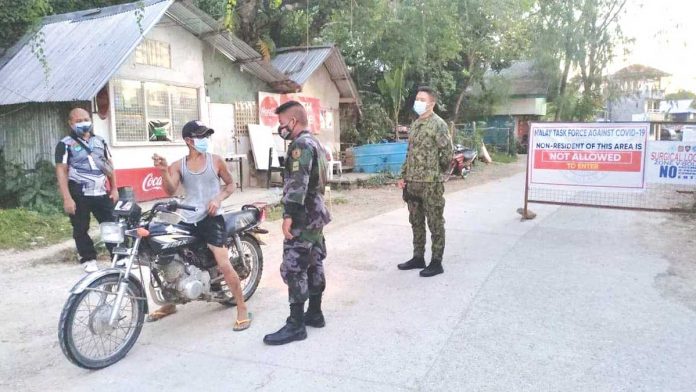 region-boracay-lifted Policemen stop a motorist at a checkpoint in Barangay Manocmanoc, Boracay Island. Zones 1 and 7 of the village have been on surgical lockdown since April 1 due to rising cases of coronavirus disease 2019.