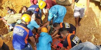 Rescuers put on a stretcher a man they pulled out from a landslide-hit area in Sitio Putol, Barangay Caticlan, Malay, Aklan on Saturday. MALAY, AKLAN BFP PHOTO